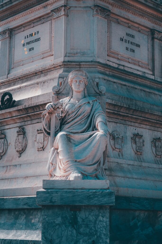 a statue of a woman sitting on a pedestal
