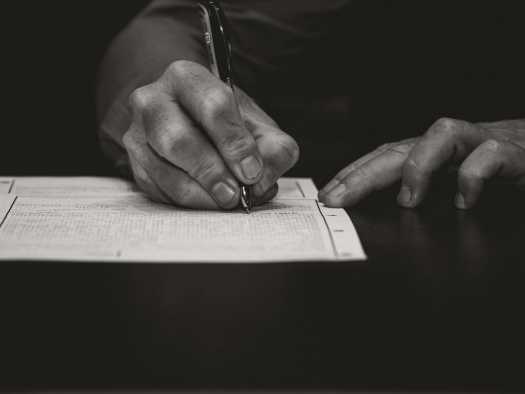 Hand writing with a fountain pen on paper.